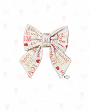Load image into Gallery viewer, Sailor bow with 'love' and heart patterns on a white background with elastic to hold onto dog collar
