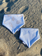 Reversible beach-themed dog bandana with seashells and blue and white stripes