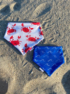 Reversible beach-themed dog bandana with red crabs and blue waves